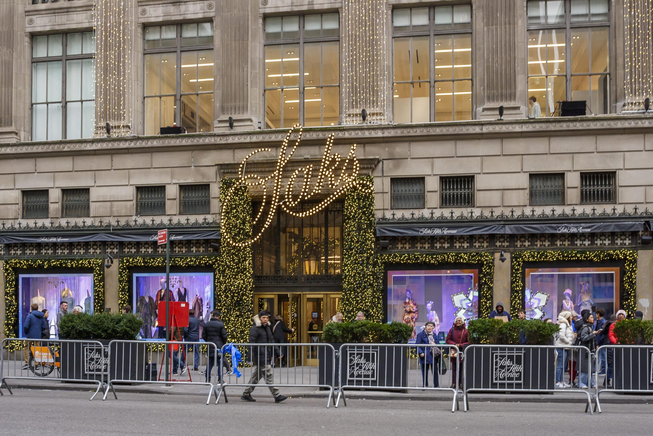 Saks Fifth Avenue and Neiman Marcus storefronts representing Saks Global luxury retail.
